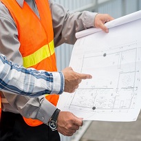 Two workers discussing blueprint