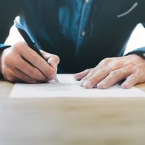 Photo of person completing paperwork