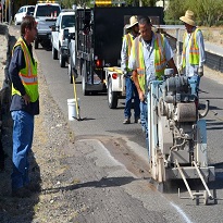 city employees working on a street