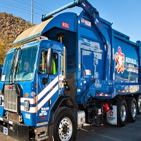 Garbage truck driving down the road