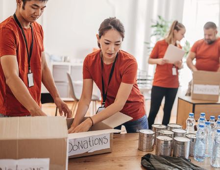 People putting things in boxes for donations picture