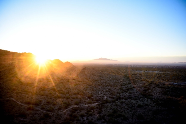 Sun rising over mountain