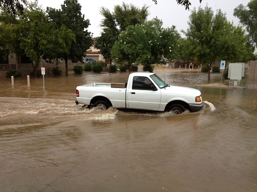 Truck drives through flooded roadway. www.istockphoto.com/portfolio/EuToch